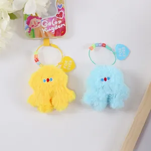 Detail of plush monster keychains with colorful smiley beads and heart charm