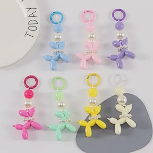 Detail of colorful balloon dog keychains with pearls in blue pink purple and yellow
