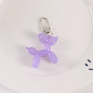 Detail of purple translucent resin balloon dog keychain with silver metal spring clasp