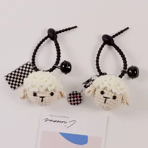 Handmade crochet sheep keychains with checkered tag and metal bell charms