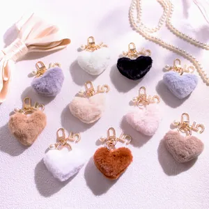 Plush heart keychains in various colors with gold hardware and decorative pearls