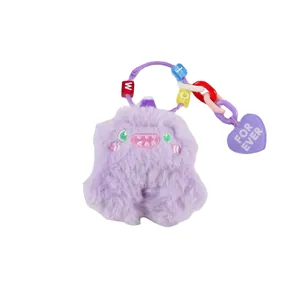 Purple plush monster keychain with colorful letter beads and heart charm on white background