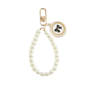Elegant pearl bead keychain with golden lobster clasp and number five bow pendant