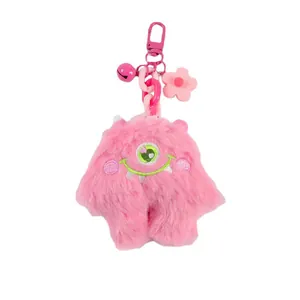 Pink furry monster keychain with green big eye, small bell and flower accessory
