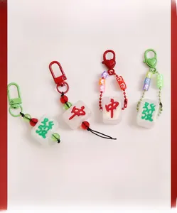 Macro detail of glittery mahjong charms with red hearts and colorful beaded chains