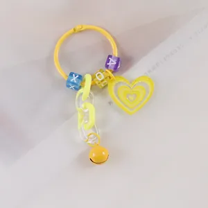 Dettaglio portachiavi a cuore giallo con catena acrilica, lettere e campanellino