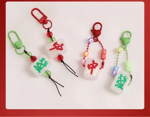 Close-up of glitter resin mahjong pendants with colorful beads and metal buckles