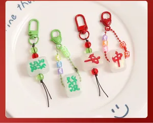 Detailed view of resin Mahjong keychains with glitter, heart charms and metal clasps