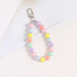 Macro shot of colorful acrylic macaron bead keychain with a silver lobster clasp detail