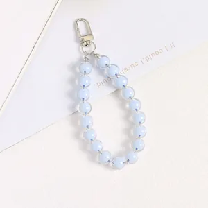 Close-up of light blue acrylic beads with clear outer shell and silver spring clasp
