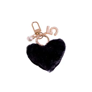 Black heart faux fur keychain with gold number 5 pendant and elegant pearl accents