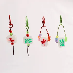 Red and green Mahjong keychain pendants set with colorful beads and metal lobster clasps