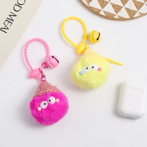 Detailed macro view of colorful plush ball keychains with knit hats and small bells