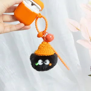 Cute black plush keychain with yellow knit hat and orange bell on silicone earphone case