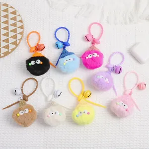Detailed overhead view of eight colorful plush monster keychains with bells and rings