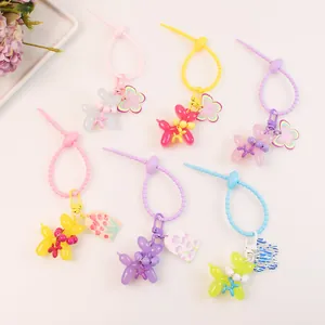 Macro view of six colorful jelly balloon dog keychains with acrylic charms and straps