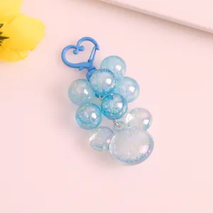Blue translucent resin grape keychain with sparkling glitter and heart-shaped spring clip