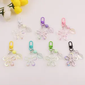 Flat lay of colorful acrylic flower keychains with frosted beads and translucent leaves