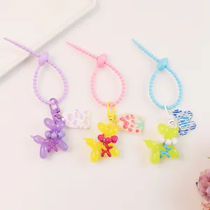 Detailed view of colorful jelly balloon dog keychains with floral charms and beads