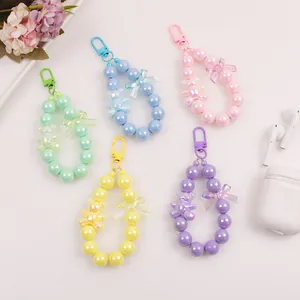 Five assorted pastel bead keychains with iridescent bears and bows for bags or cases