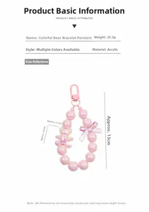 Detail of pink pearlescent beaded keychain with acrylic bear charm and metal clasp