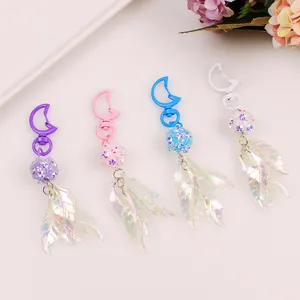Detail of colorful leaf pendants and glitter bead keychains in purple and blue