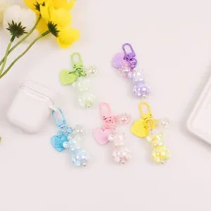Detailed view of colorful iridescent bear charms with heart tags and floral accents