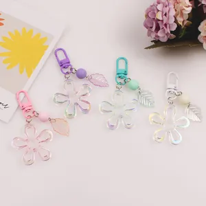 Detail view of colorful acrylic flower keychains with frosted beads and leaf charms