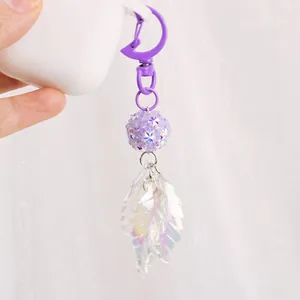 Sweet Korean style rhinestone beaded keychain with iridescent leaf pendant on white case