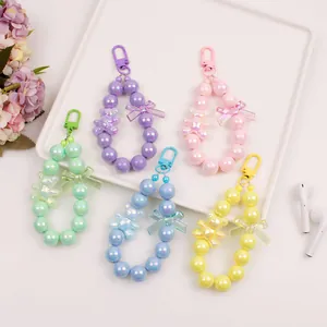 Close-up of colorful beaded keychains with iridescent bears and bowknot charms