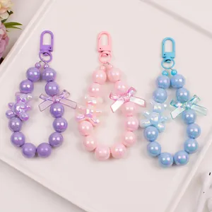 Close-up of cute cartoon bear beaded keychain set with colorful pearlescent resin beads