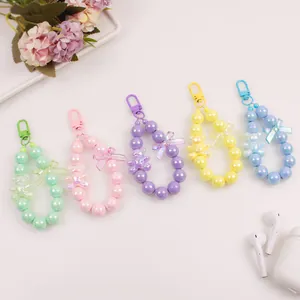 Macro view of colorful beaded bear charms for keys or earbuds in various pastel shades