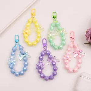 Detail of colorful acrylic bear charms and iridescent beaded keychain straps in five pastel colors