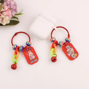 Close-up of red rabbit keychains with lucky charms and colorful acrylic beads