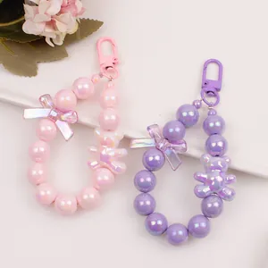 Cute cartoon bear keychain with colorful round beads and bow pendant in pink and purple