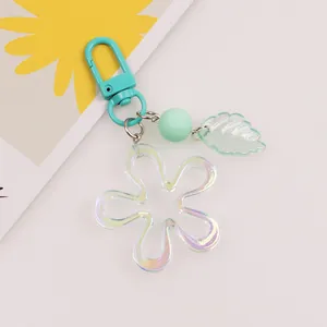 Detail of aurora acrylic flower keychain with mint green bead and leaf charm
