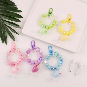 Close-up of pastel beaded keychains with mini bubble tea cups and letter beads charms