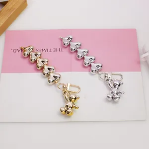 Silver and gold metallic heart bead chain keychains with cute bear charms on pink card