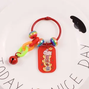 Close-up of red lucky rabbit charm with Chinese characters on a white ceramic plate