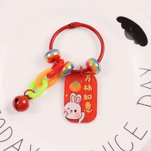 Close-up of lucky rabbit keychain with red metal tag and colorful decorative beads
