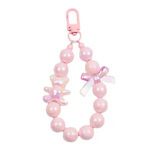 Pink pearlescent bear bead keychain with colorful butterfly charm and spring hook