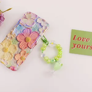 3D embossed floral phone case with milk tea charm and green beaded wrist strap