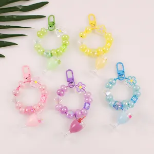 Close-up of pastel milk tea cup keychains with colorful acrylic beads and star charms