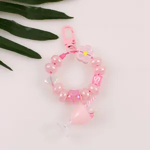 Detail view of pink milk tea keychain with beaded letters and acrylic charms