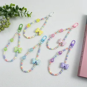 Close-up of pastel beaded keychain set with polka dot bows in five macaron colors