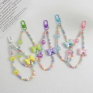 Detail view of colorful beaded phone straps with pastel bow charms in four colors