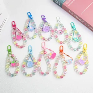 Flat lay of colorful acrylic beaded keychains with charms like stars and flowers