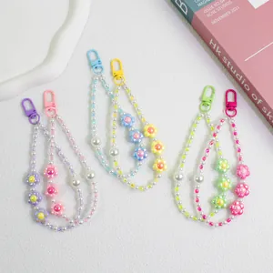 Detail view of colorful floral beaded keychains with pearls and macaron sun flower charms