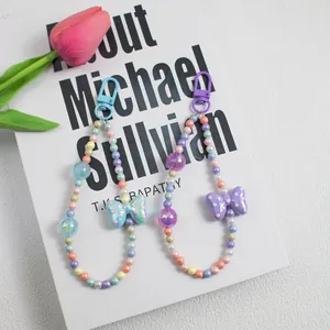 Polka dot bow and colorful beaded phone strap charms in blue and purple styles