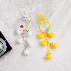 Detail of colorful duck charms with smiley beads on vibrant keychains and metal rings